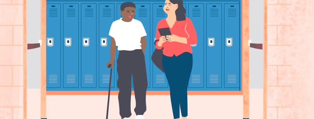 Two students in a classroom hallway one student has a cane