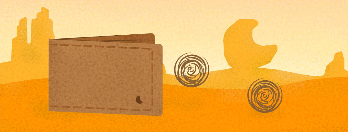 a wallet in a desert with tumbleweeds coming out
