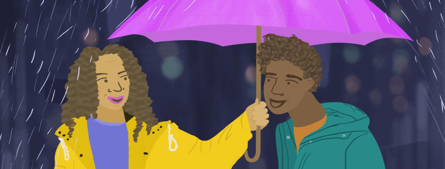 A woman holding up an umbrella for a man.