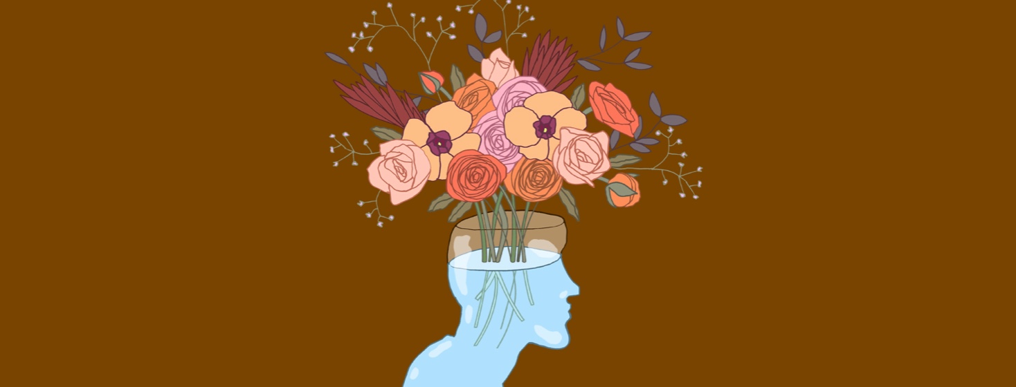 a glass head is actually a vase filled with water and a beautiful bouquet of flowers.